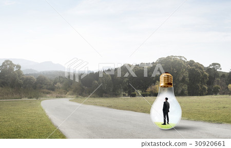 Businessman inside light bulb 30920661