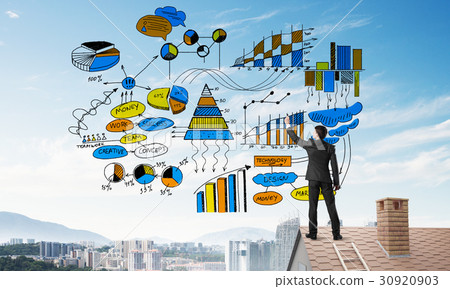Rear view of businessman on house roof drawing his new business strategy. Mixed media 30920903
