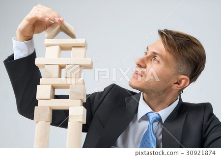 Businessman making tower Businessman making tower 30921874