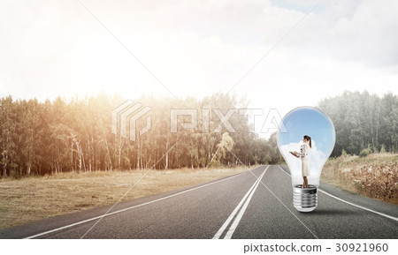Businesswoman inside light bulb Businesswoman inside light bulb 30921960