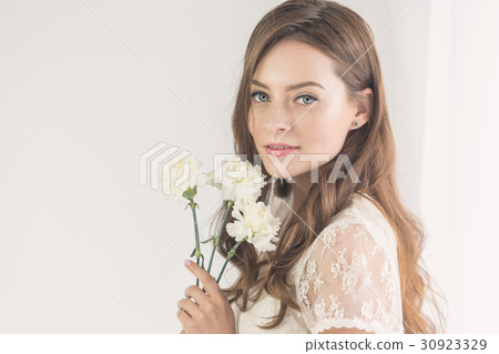 Sweet girl with a bouquet of flowers 30923329