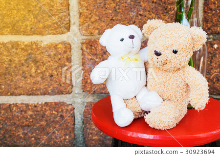 Two lovely bears brown and white on red stool Two lovely bears brown and white on red stool 30923694