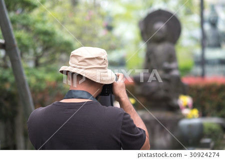 Photographer taking photo of shrine in Japan 30924274