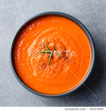 Tomato soup in a black bowl. Top view. Copy space Tomato soup in a black bowl. Top view. Copy space 30924804
