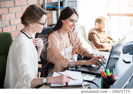 Jolly concentrated women working in office 30925775