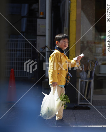 A boy walking in an obscurating shopping area A boy walking in an obscurating shopping area 30927707