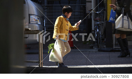 A boy walking in an obscurating shopping area 30927808