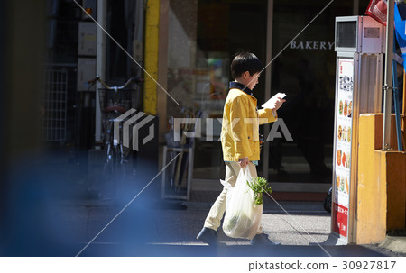 A boy walking in an obscurating shopping area 30927817