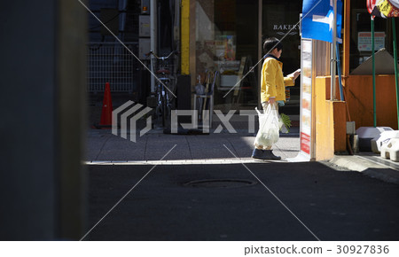 A boy walking in an obscurating shopping area 30927836