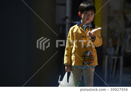 A boy walking in an obscurating shopping area 30927956