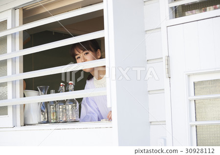 Mother watching over the window 30928112