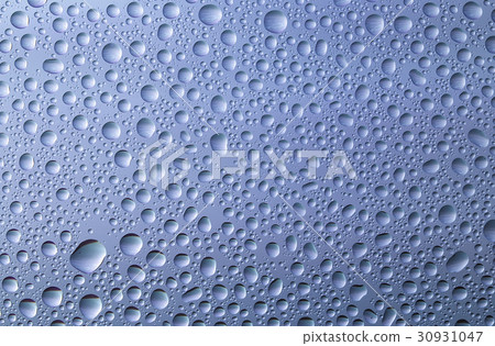 Closeup of water drops on glass surface 30931047