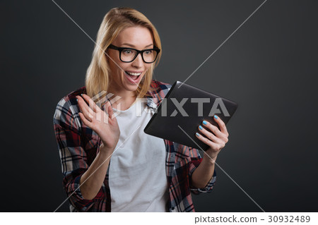 Expressive lively woman enjoying online Expressive lively woman enjoying online 30932489