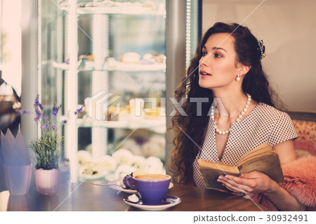 Elegant young lady alone in a cafe Elegant young lady alone in a cafe 30932491
