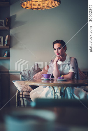 Elegant young lady alone in a cafe Elegant young lady alone in a cafe 30932843