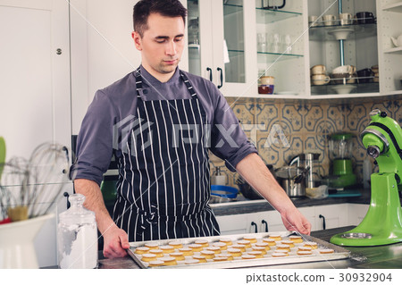 Chef cook working on a modern kitchen at home 30932904