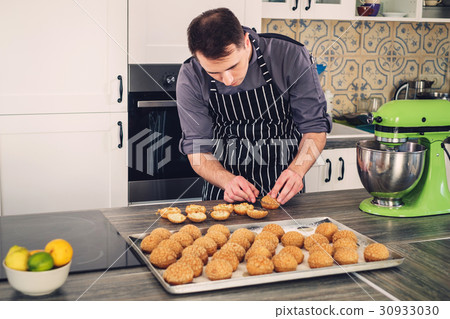 Chef cook working on a modern kitchen at home 30933030