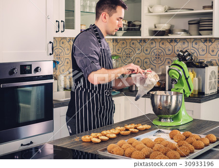 Chef cook working on a modern kitchen at home Chef cook working on a modern kitchen at home 30933196
