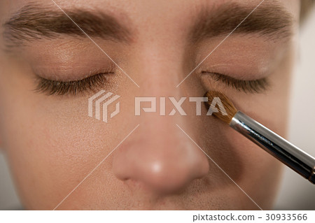 Applying concealer on man to cover dark circles Applying concealer on man to cover dark circles 30933566