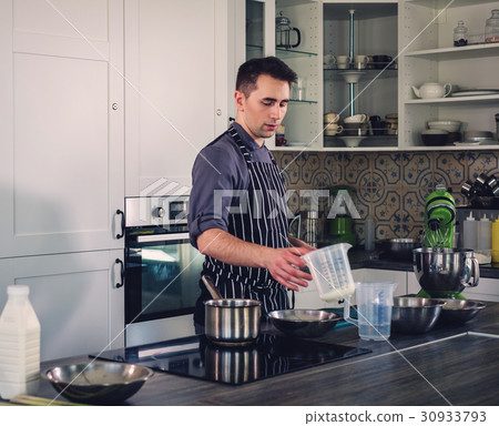 Chef cook working on a modern kitchen at home 30933793