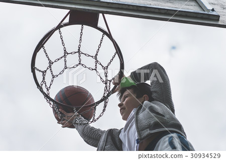 A little boy jumping and making goal basketball 30934529