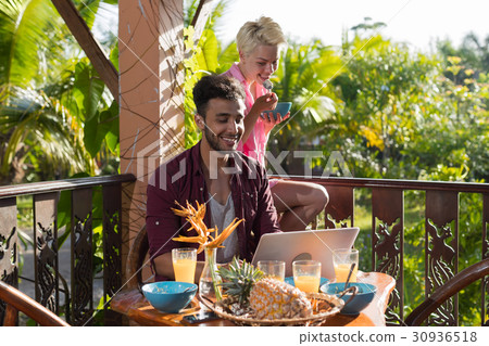 Couple Sitting On Summer Terrace Use Laptop Couple Sitting On Summer Terrace Use Laptop 30936518