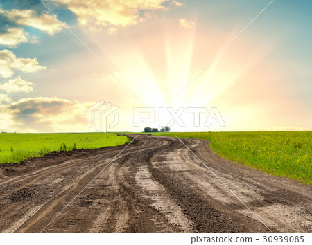 A dirt road against beautiful sunrise A dirt road against beautiful sunrise 30939085