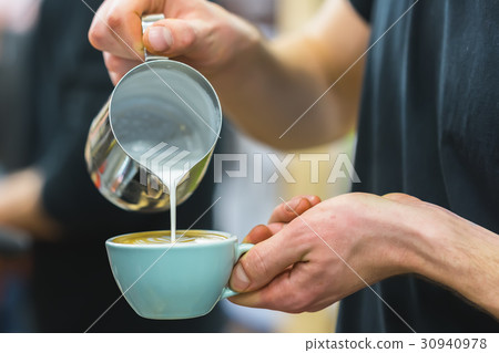 Barista in coffee bar preparing proper cappuccino Barista in coffee bar preparing proper cappuccino 30940978