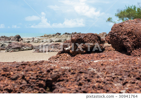 red stone and rock on the sand beach in clear sky 30941764