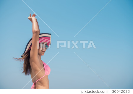 Sexy bikini body asian woman playful on beach. 30942023