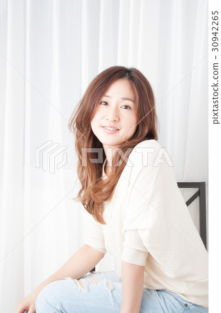 Woman sitting on chair 30942265