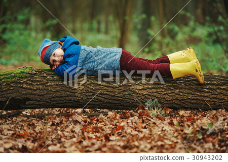 little funny boy on big log 30943202