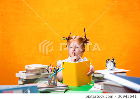 The Redhead teen girl with lot of books at home 30943641