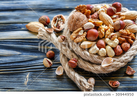 Hemp rope and a mixed of nuts. Hemp rope and a mixed of nuts. 30944950
