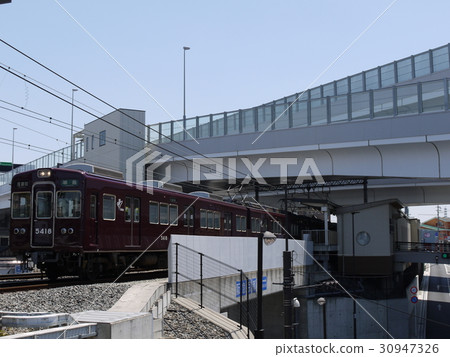 Station and train crossing highway 30947326