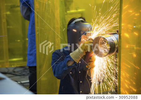 The welding craftsman grinding the steel tube The welding craftsman grinding the steel tube 30952088