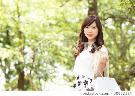 A young woman on the way home from shopping 30952154