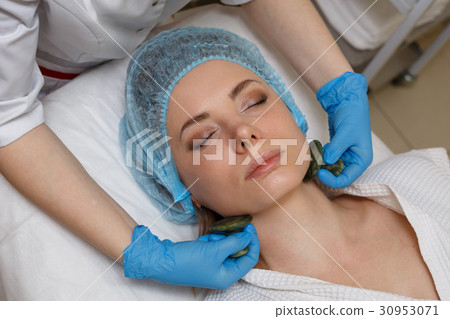 Massage with jade stones. Gua sha Massage with jade stones. Gua sha 30953071