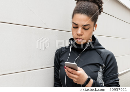 Woman in sportswear checking app  30957921