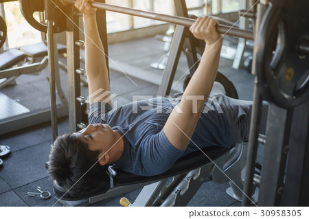 Young Asian man exercising in the fitness gym 30958305