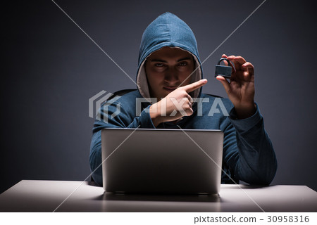 Computer hacker working in dark room Computer hacker working in dark room 30958316