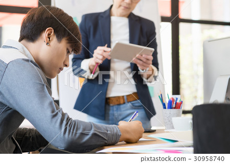 Woman boss coaching and teaching in modern office. 30958740