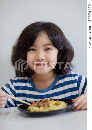 Happy Asian child eating delicious noodle Happy Asian child eating delicious noodle 30959190