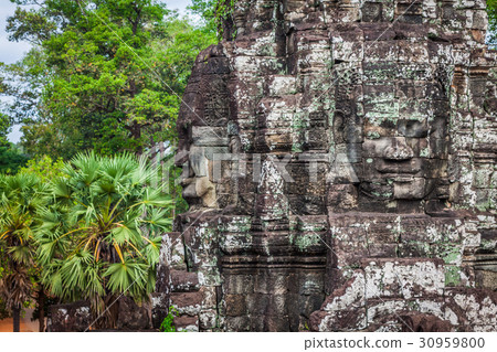 Ancient stone faces of Bayon temple, Angkor 30959800