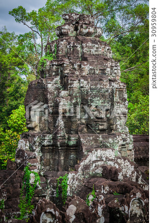 Ancient stone faces of Bayon temple, Angkor Ancient stone faces of Bayon temple, Angkor 30959804