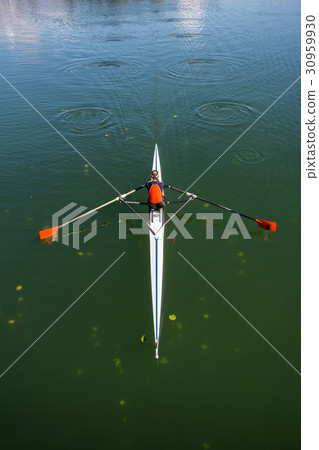 Young woman rowing in boat on the lake 30959930