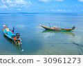 Long tail boat floating on the sea 30961273