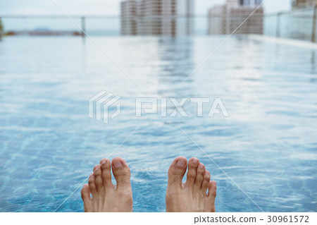 Relaxing in summer, on roof top swimming pool  30961572