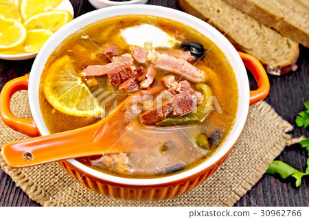 Solyanka with lemon and black olives in bowl Solyanka with lemon and black olives in bowl 30962766