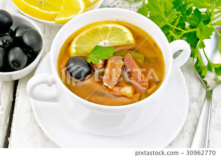 Solyanka with lemon in white bowl on board 30962770